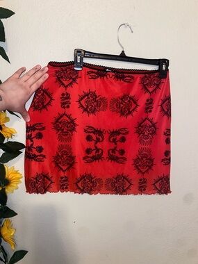 Dolls Kill Horoscopez red sheer mini skirt with black graphics